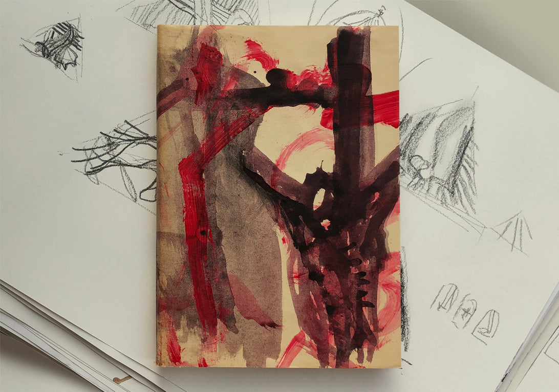 Bogcover til Forræderens Evangelium med rød og sort kunst af Peter Ejlerskov.